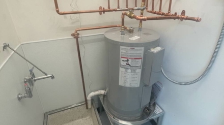 Plumber executing a hot water heater installation