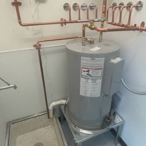 Plumber executing a hot water heater installation