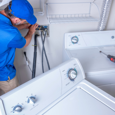 Plumber installing a washer and dryer