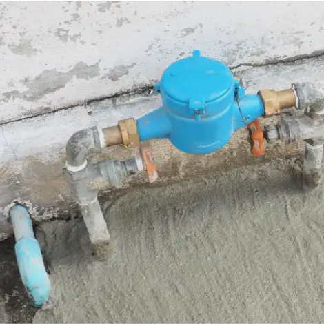 Plumber installing water valve outside for residential property