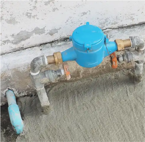Plumber installing water valve outside for residential property