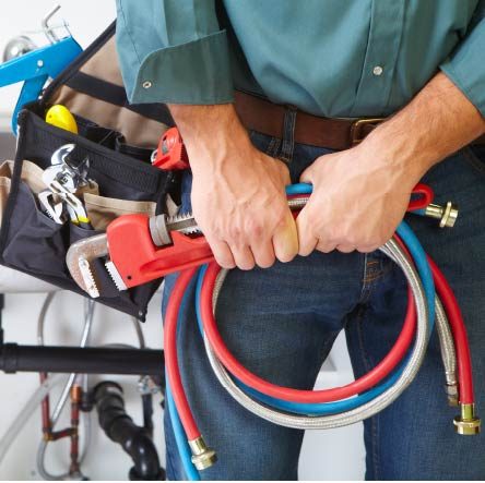 Nashville plumber from ALL PIPES, equipped with a tool bag and pipe wrench, ready to install hot and cold lines in your home or business.