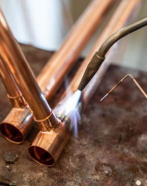 Nashville plumber from ALL PIPES skillfully welding copper piping